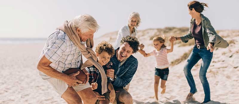 Retired Couple on Beach With Family