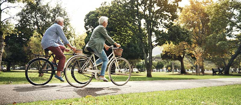 Retirees Riding Bicycles on Path